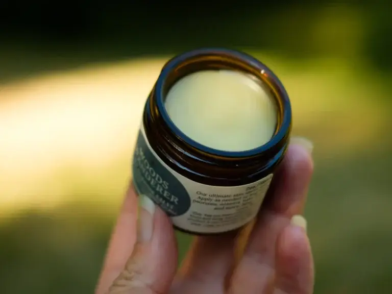 Open jar of balm – camphor and balm ingredients for pain relief rubs and ointments