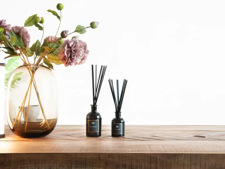 Reed diffusers on a wooden shelf – fragrance ingredients for diffusers and home wellness