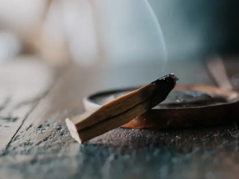 Incense and wood on a table – woody and grounding aroma ingredients for wellness